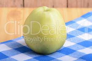 Fresh green apple on blue material backgound