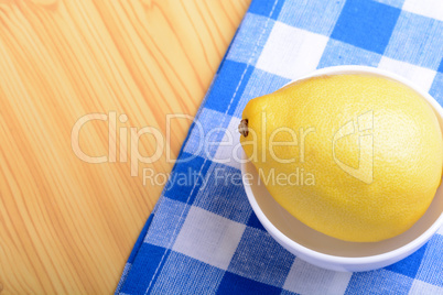 ripe lemons on a white plate