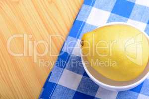 ripe lemons on a white plate