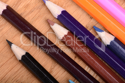 Frame of old Colour pencils on Old wooden plate texture background