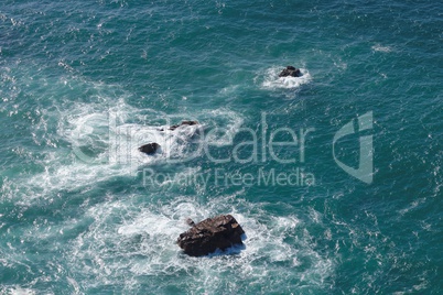 Waves breaking on rocks in sea