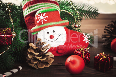 Christmas sock with toys and gifts on wooden background with Christmas tree