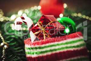 Christmas sock with toys and gifts on wooden background with Christmas tree