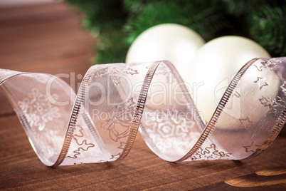 Christmas background with white ribbon and Christmas balls on wooden background