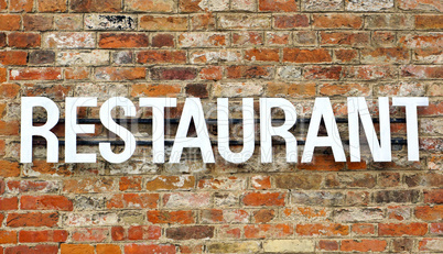 Old Restaurant sign on stone wall
