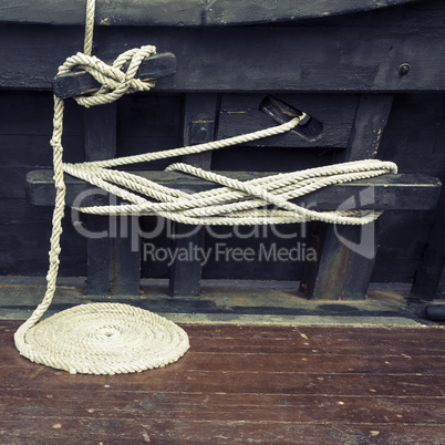 Coiled maritime rope on wooden deck