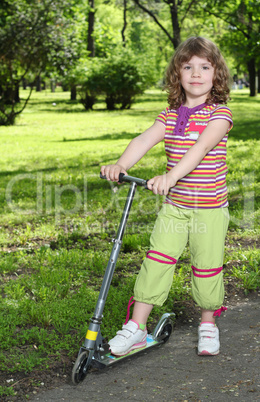 beautiful little girl with scooter posing