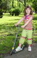 beautiful little girl with scooter posing