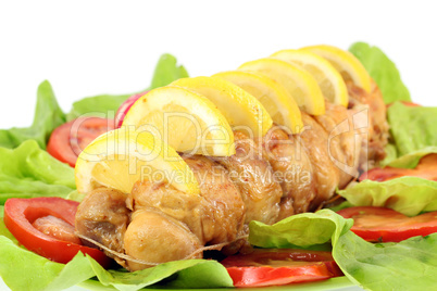 rolled chicken meat with lemon and salad