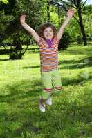 happy little girl jumping in park