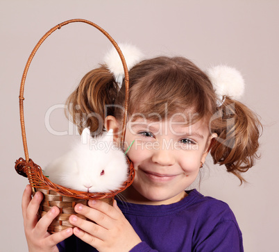 happy little girl with dwarf bunny pet