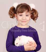 little girl holding dwarf bunny pet