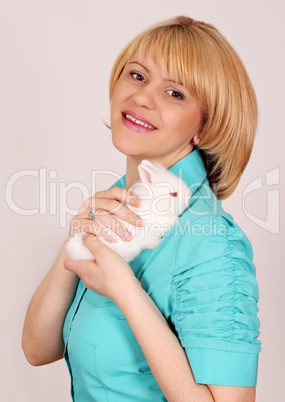 beautiful girl holding dwarf white rabbit