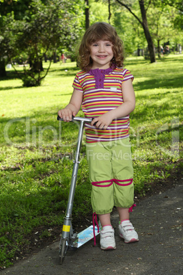 happy little girl with scooter