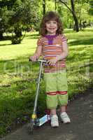 happy little girl with scooter