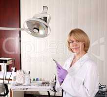 female dentist with borer posing
