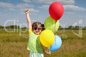 happy little girl with balloons