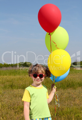 little girl with colorful balloons posing