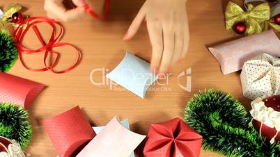Christmas gift in a small box with a red ribbon