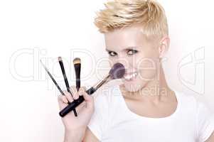 Make-up artist holding brushes