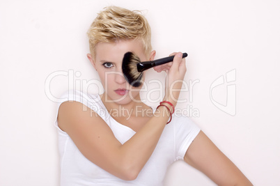 Make-up artist holding brushes