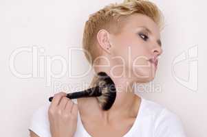 Make-up artist holding brushes