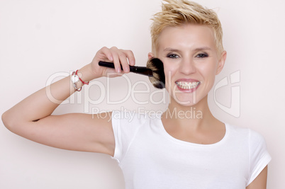 Make-up artist holding brushes