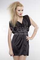 Young pretty woman with beautiful blond hairs in black dress