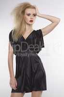 Young pretty woman with beautiful blond hairs in black dress