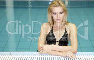 beautiful young woman standing in a swimming pool