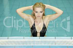 beautiful young woman standing in a swimming pool