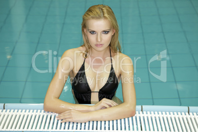 beautiful young woman standing in a swimming pool