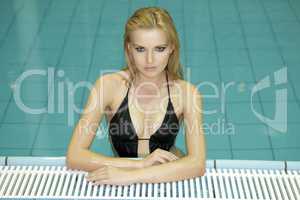 beautiful young woman standing in a swimming pool