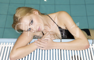 beautiful young woman standing in a swimming pool