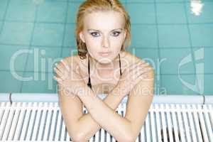 beautiful young woman standing in a swimming pool