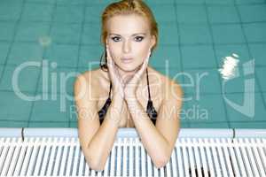 beautiful young woman standing in a swimming pool