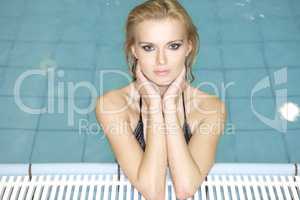 beautiful young woman standing in a swimming pool