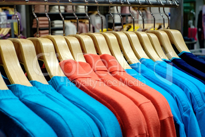 Clothing on hangers in shop