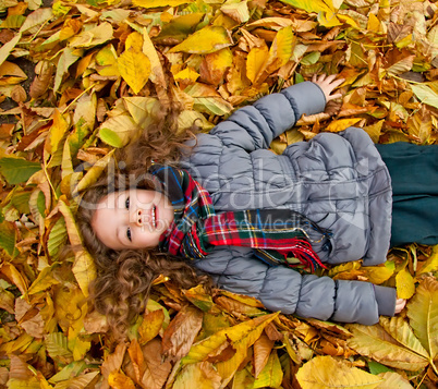 Little Girl Playing With Autumn Leaves