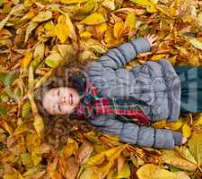 Little Girl Playing With Autumn Leaves