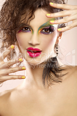 young attracive female face with multicolored make-up