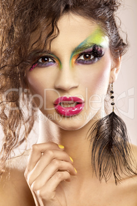 young attracive female face with multicolored make-up
