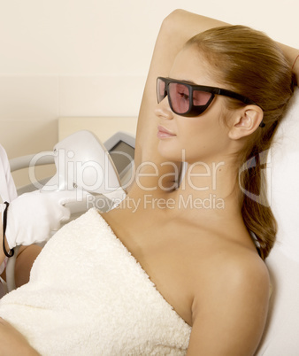 Young woman receiving laser therapy