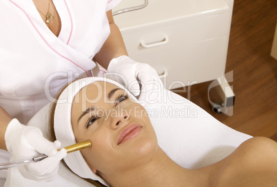 Young woman receiving laser therapy