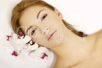 Beauty face of the young beautiful woman with flower