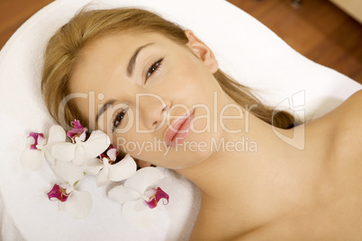 Beauty face of the young beautiful woman with flower