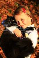 girl embracing with her cat in Autumn