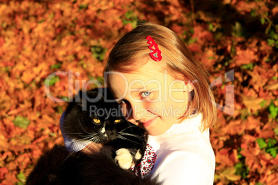 girl embracing with her cat in Autumn