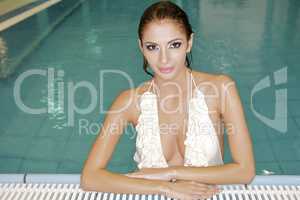 beautiful young woman standing in a swimming pool