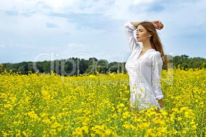 brunette woman in a yellow flowers field